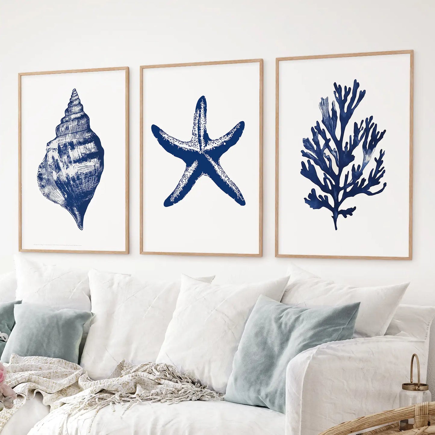 Contemporary beach room wall art. Trendy watercolor apartment decor. Thinwood frames above the sofa.