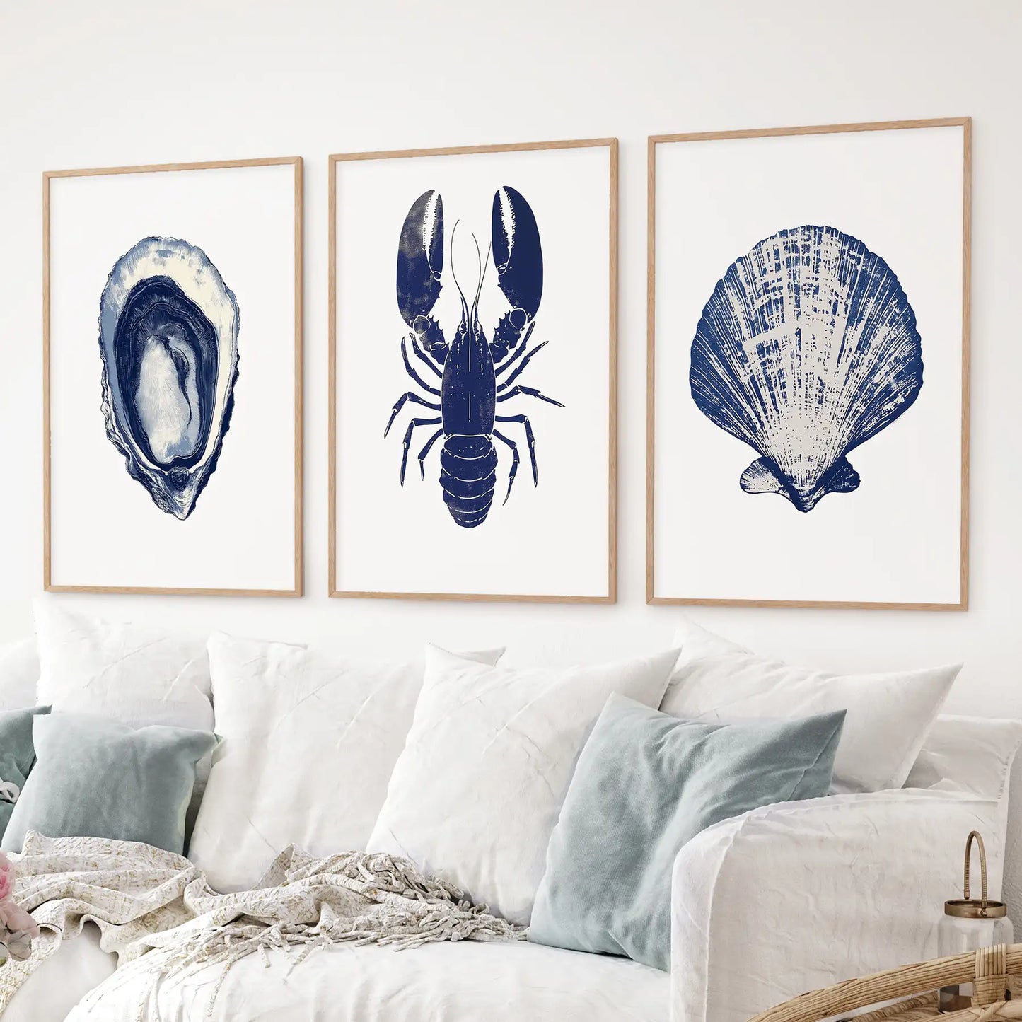 Blue coastal bathroom decor. Nautical ocean beach house prints. Thinwood frames above the sofa.