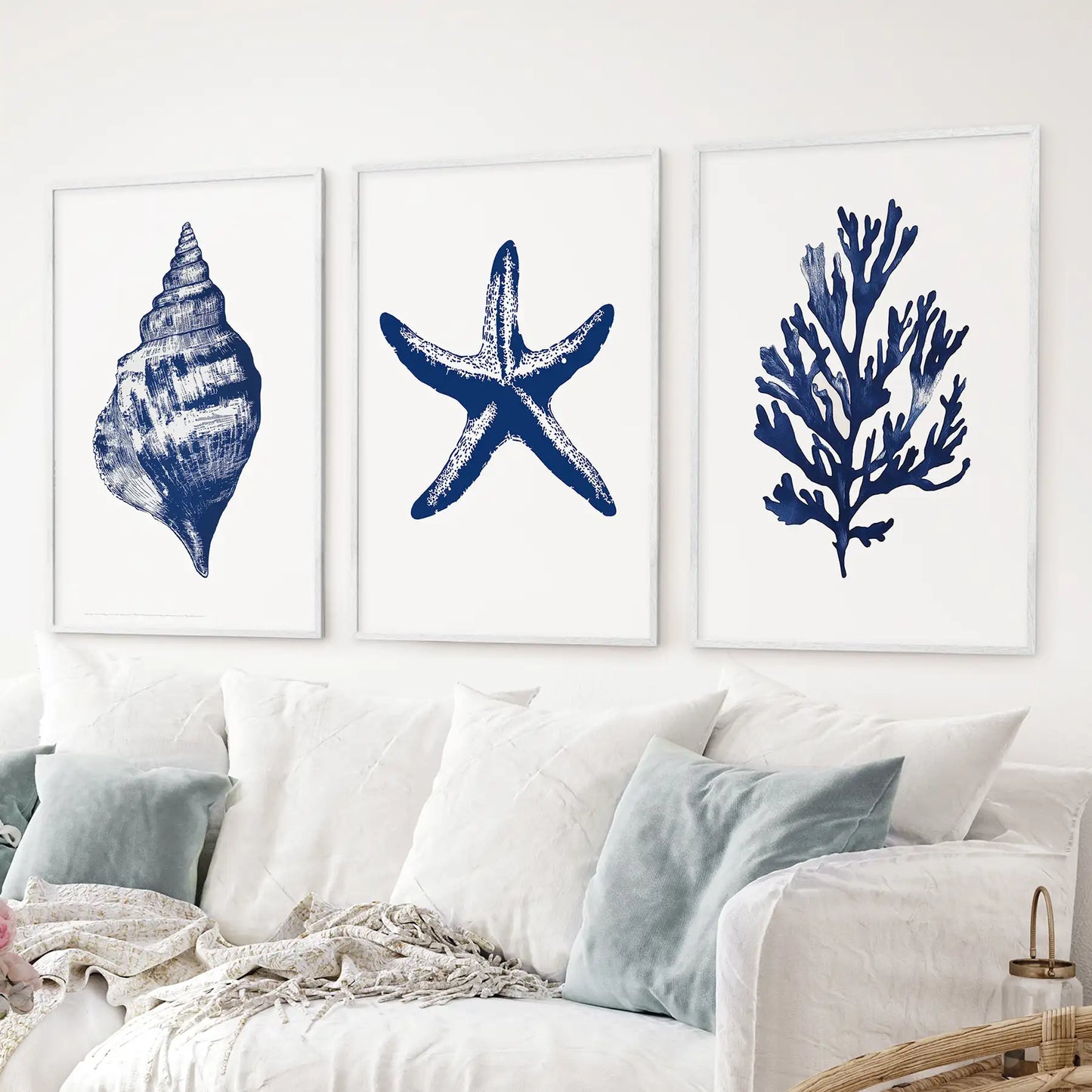 Watercolor sea life prints set of 3. Navy blue trendy coastal wall art. White frames over the couch.