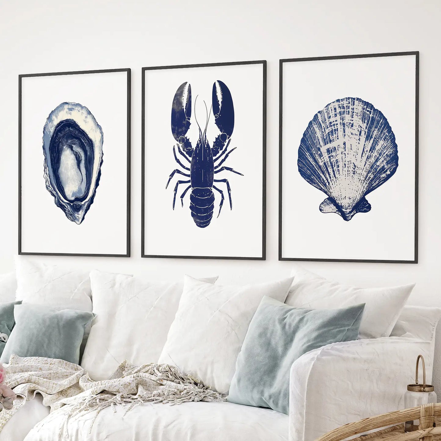 Navy blue wall decor print. Ocean themed shell, lobster painting art. Black frames over the couch.
