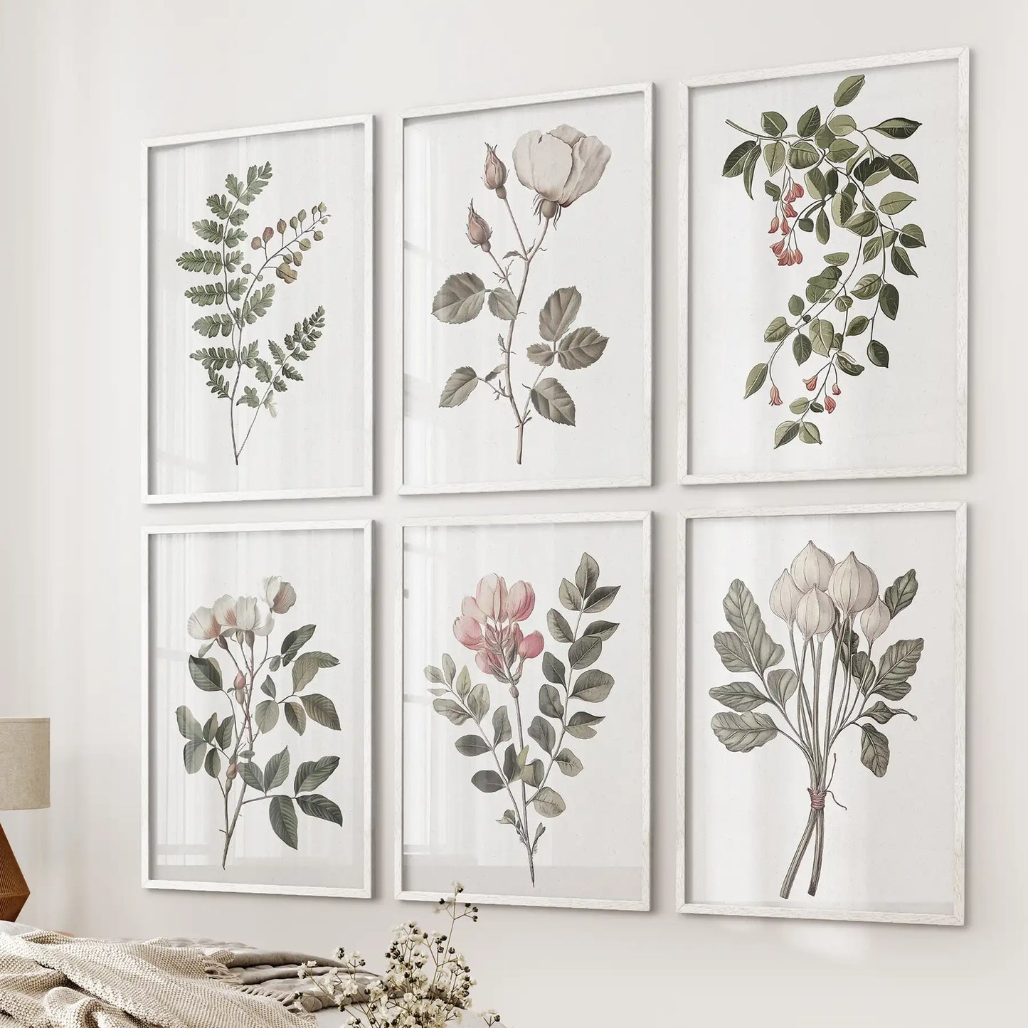 Watercolor botanical trendy painting. White rose vintage flowers home decor. White frames over the bed.