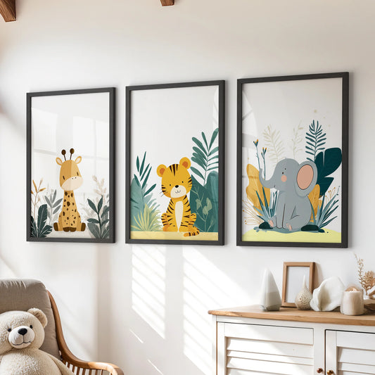 Watercolor safari animals wall art set of three in slim black frames, styled for a kids playroom and hanging over a chest of drawers.