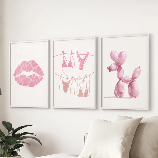 Pink lips art prints, a 3-print bundle, add a cheeky note to the living room, with clean white frames lined above the couch for a crisp display.