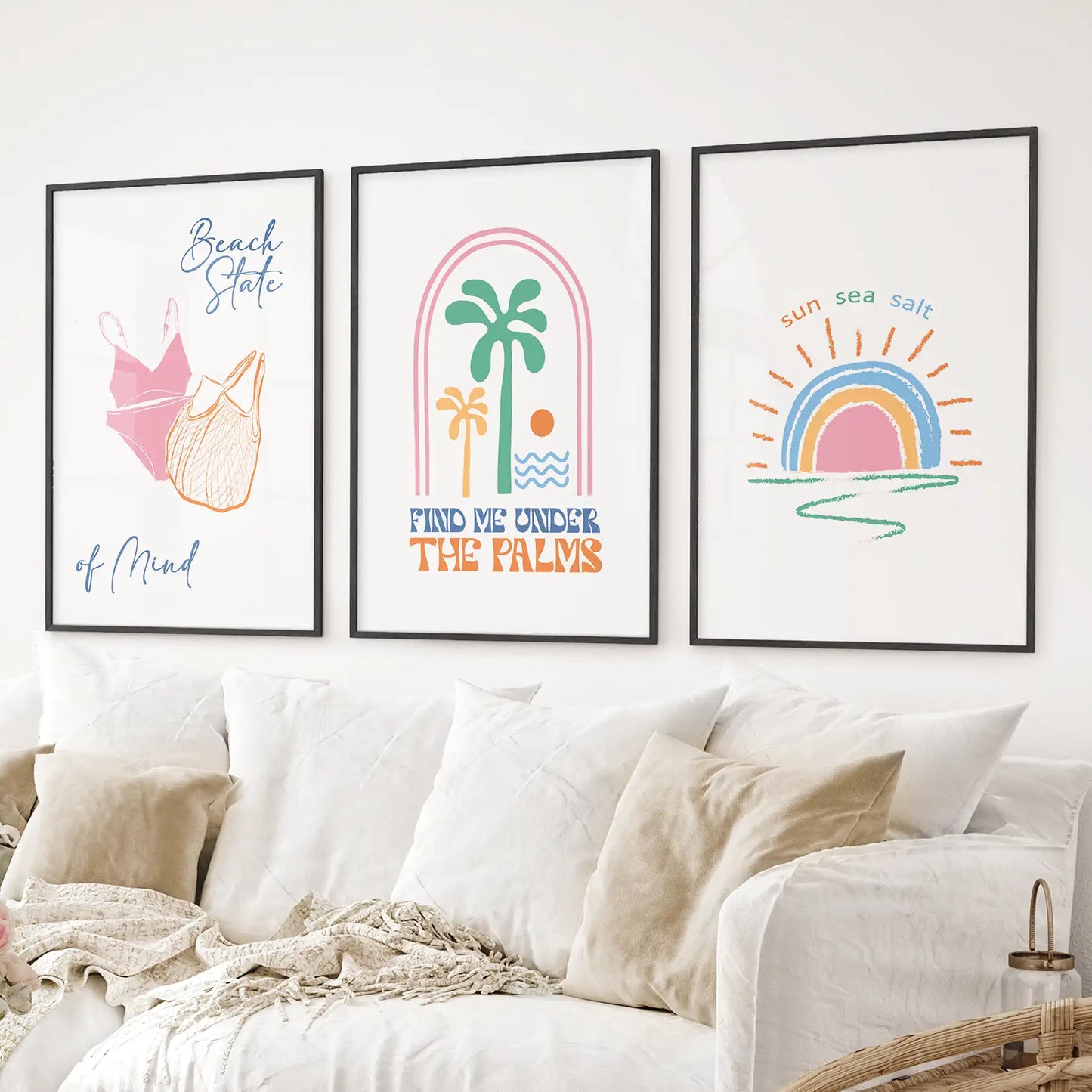 Colorful coastal wall prints with palm, rainbow sunset, and summer vibes. Black frames above the sofa.