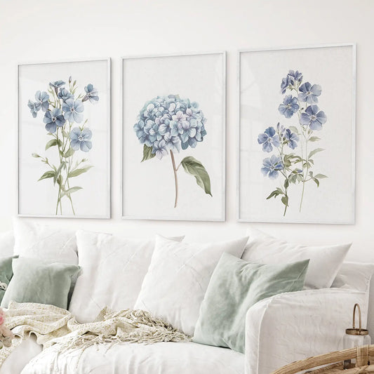 Soft pastel floral artwork hydrangea and delicate wildflowers. White flowers above the sofa.