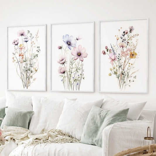 Botanical floral prints with pink, purple, and yellow flowers. White frames above the sofa.