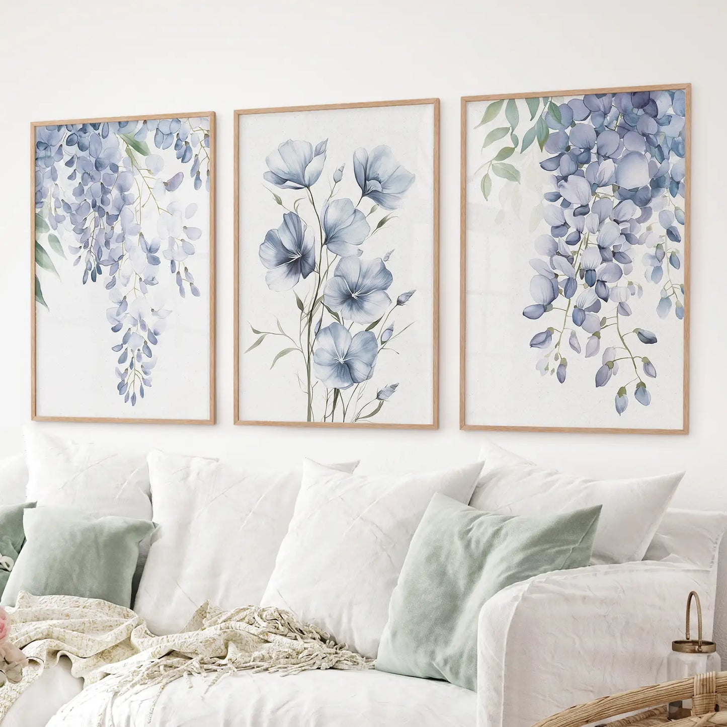 Gallery wall with 3 watercolor botanical prints of cascading wisteria and blue flax. Thinwood frames over the couch.