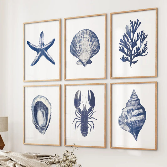 Blue ocean themed illustrations. Trendy coastal gallery wall set of 6 piece. Thinwood frames above the bed.