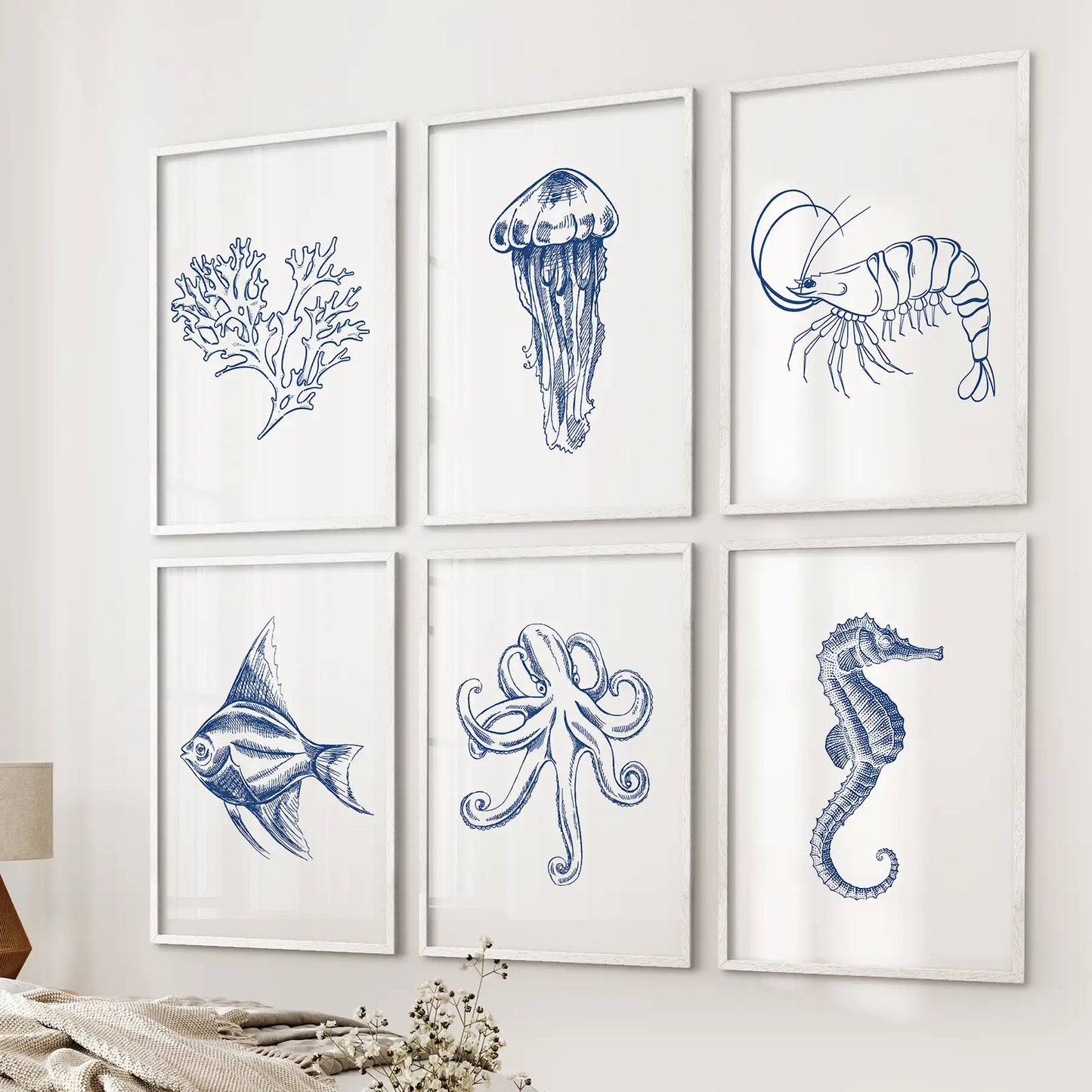 Set of 6 minimalist nautical wall art. Ocean art print coral, octopus, fish, jellyfish home decor. White frames above the bed.