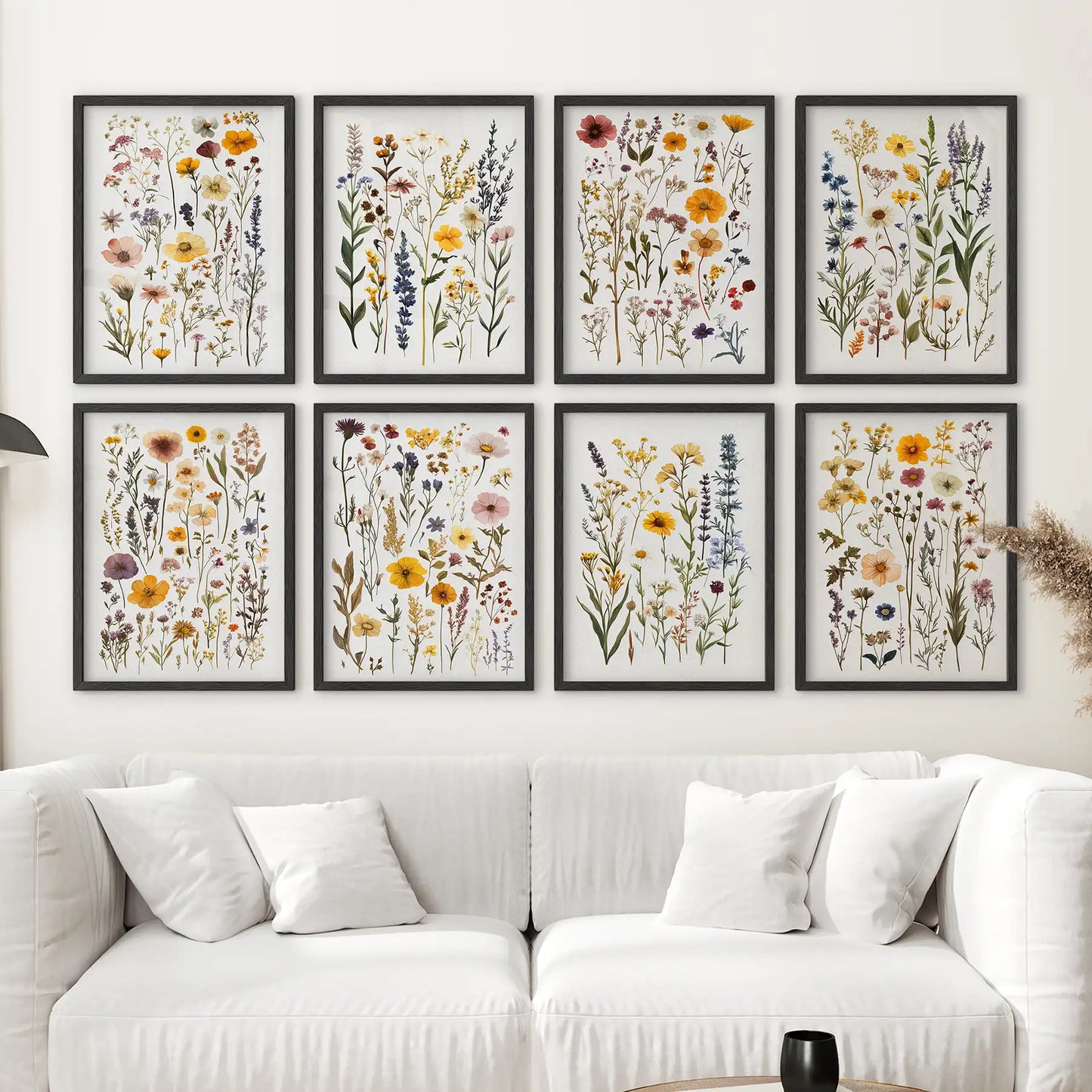 Pressed flower artwork set with delicate wild blooms. Floral gallery wall decor. Black frames for cozy and bright room decor.