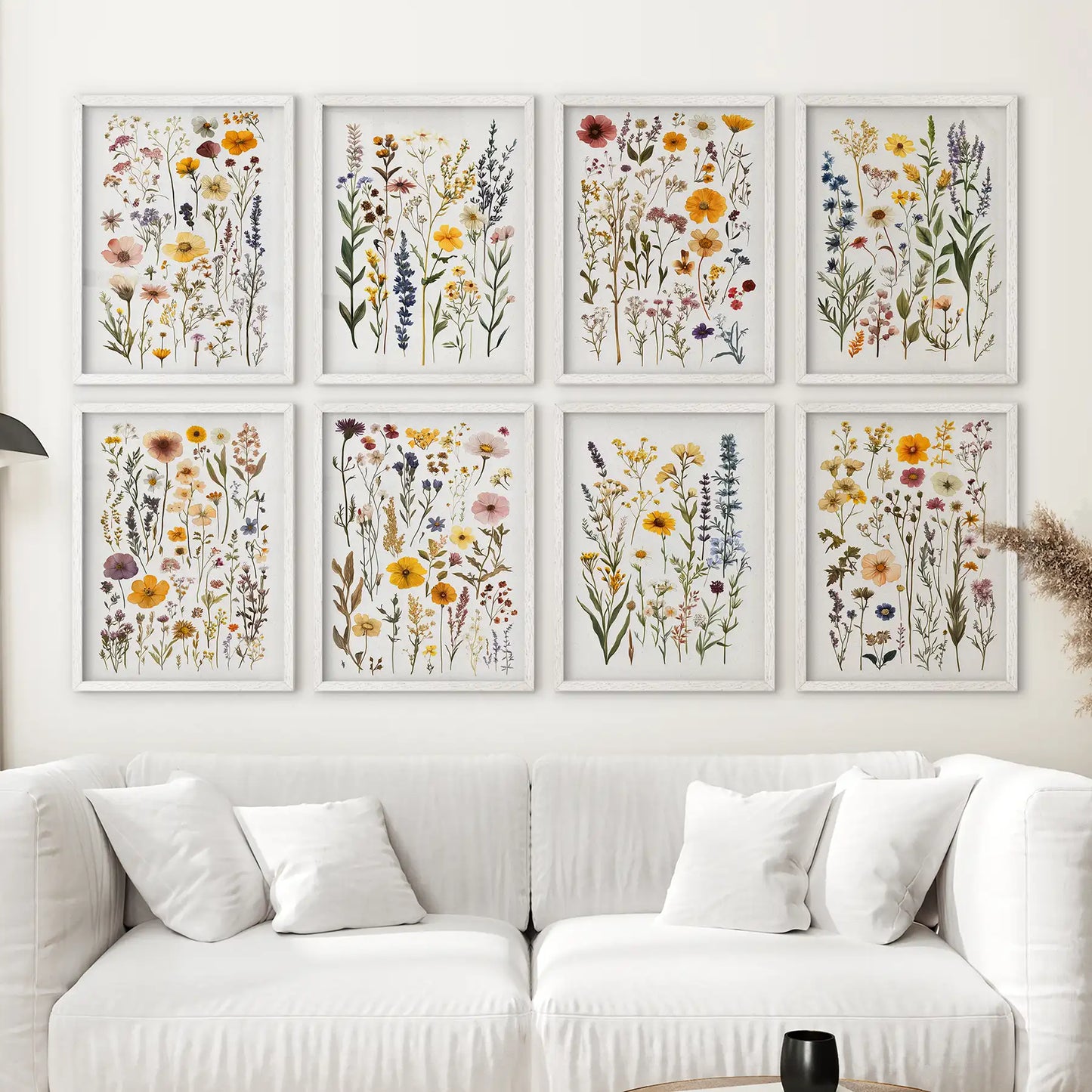 Colorful botanical wall art set of 8 prints featuring wildflowers and herbs. White frame over the couch.