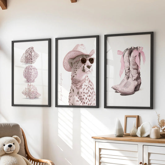 Seashells three-piece wall art set in black frames perches above a playroom chest of drawers, bringing breezy coastal charm in soft pinks.