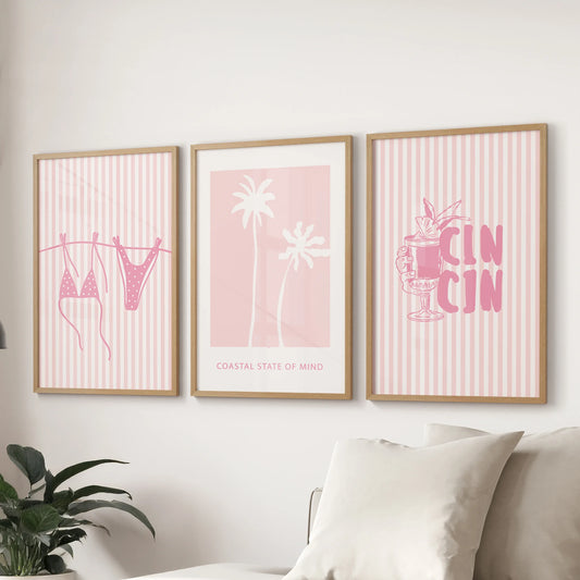 A set of three beach wall prints in slim wood frames lines the wall over the family-room sofa for an airy sun-lit coastal look.