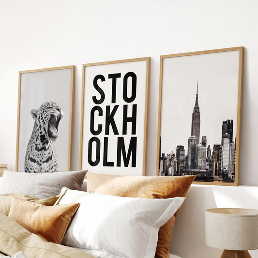 Three oak-wood-framed leopard print pictures hang over the bed, giving the bedroom wall art a textured, fashion-forward accent.