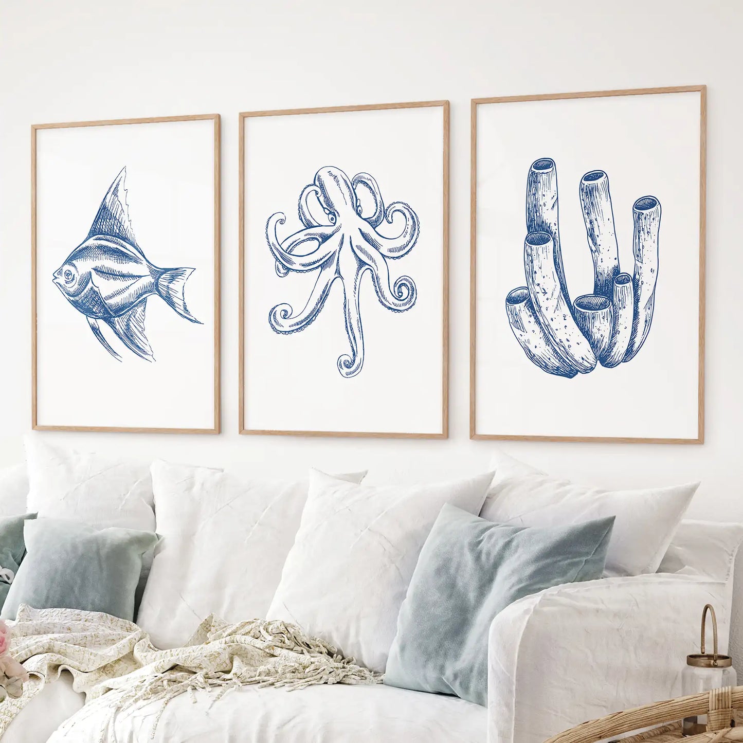 Minimalist marine life drawing art decor. Fish, Octopus, coral trendy wall prints. Thinwood frames over the couch.