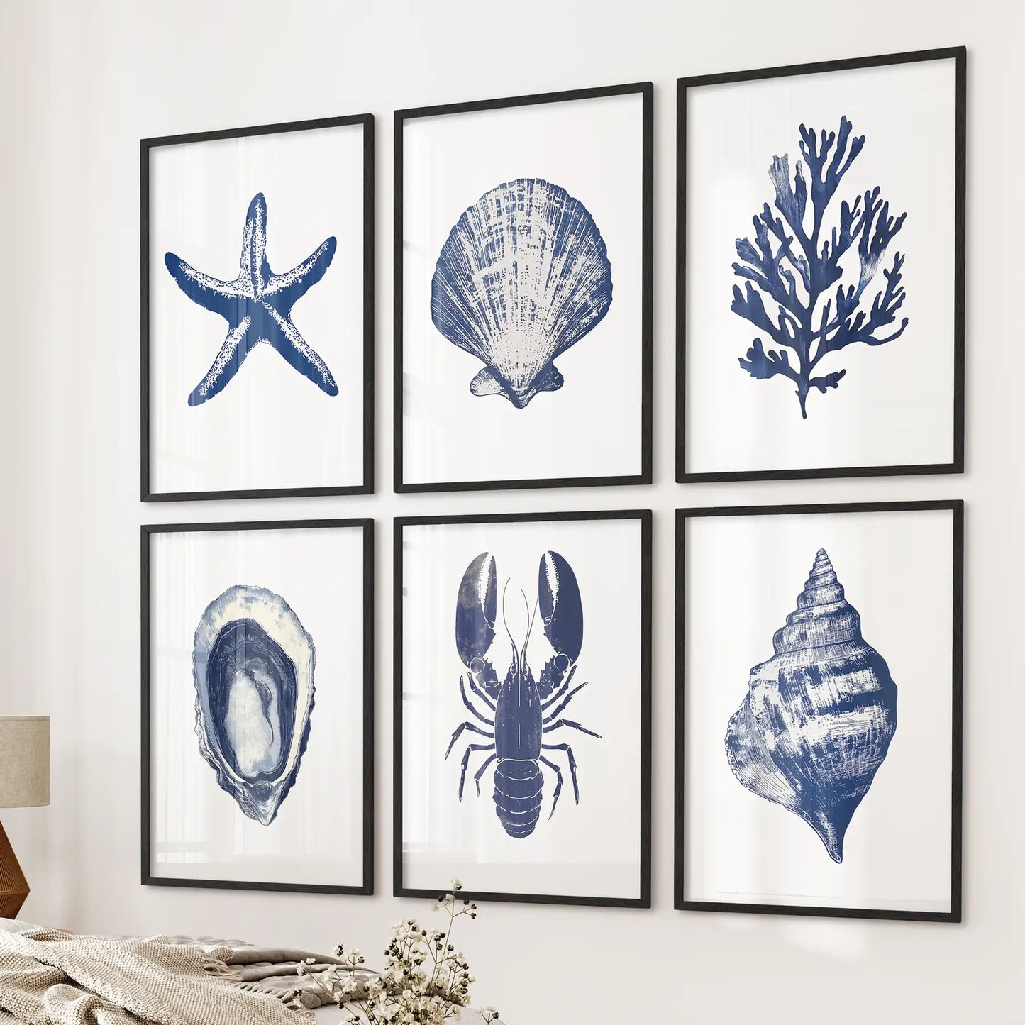 Neutral coastal large poster. Starfish ocean wall art beach house decoration. Black frames over the bed.