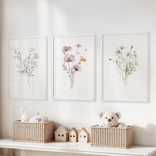 Neutral botanical florals, a three-piece wall hanging in white frames, brighten a kids playroom when displayed over the storage bench.