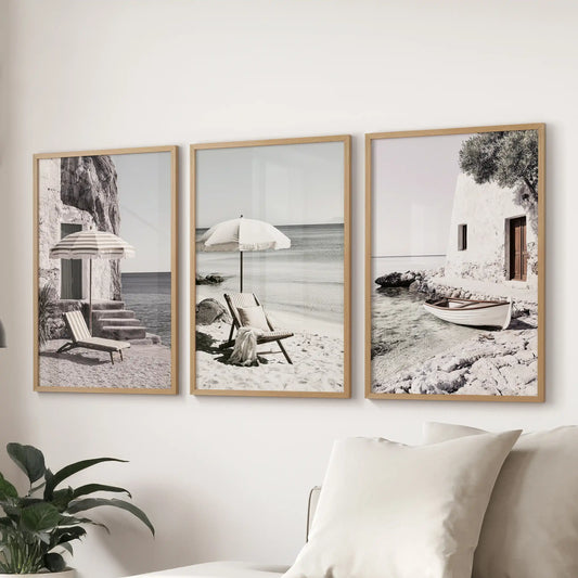 Wall art set of three displays calm ocean and shoreline scenes in oak frames. Floated above the sectional, it brings relaxed Mediterranean character to the sitting room.