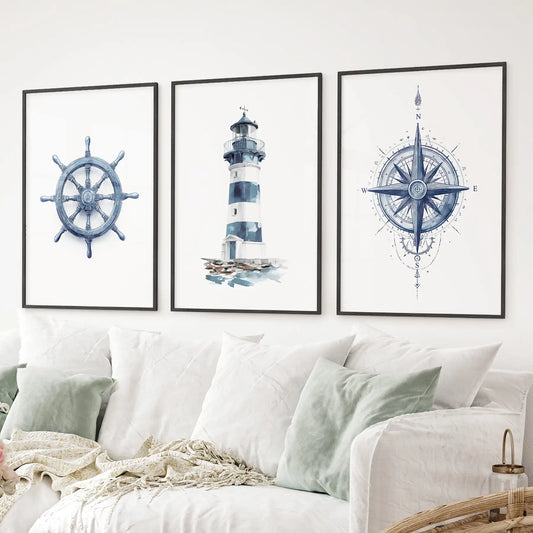 Coastal themed wall decor navy blue watercolor artwork of compass, ship wheel, and lighthouse. Black frames for living room.
