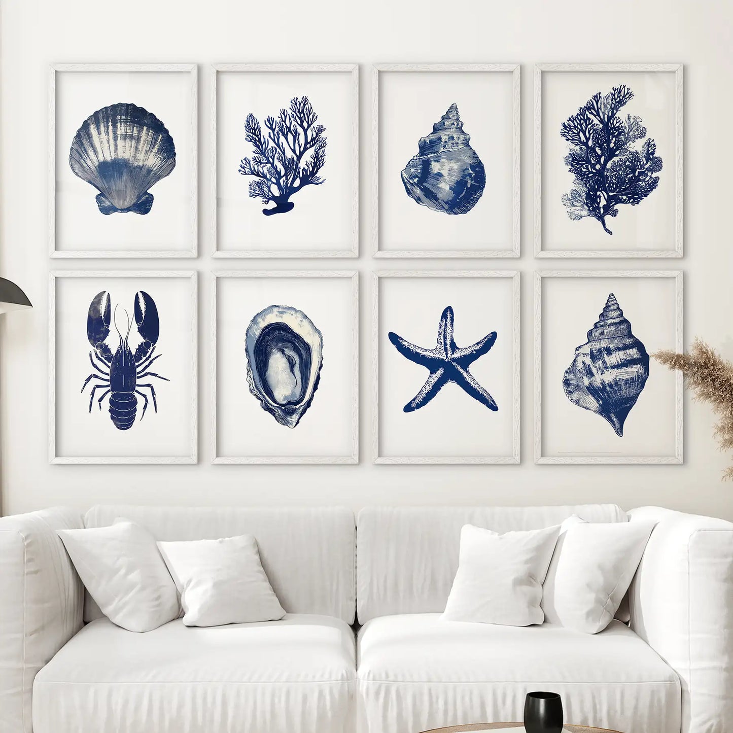 Trendy nautical watercolor paintings. Blue coastal sea animal wall art prints. White frames above the sofa.