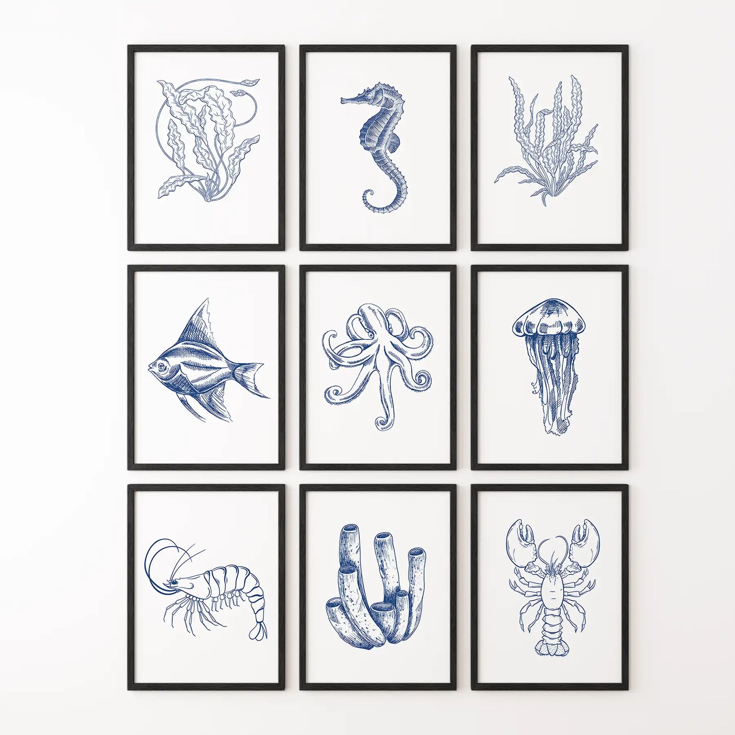 Marine life art set with navy sea creatures, coral, and shells for coastal interior. Black frames for hallway.