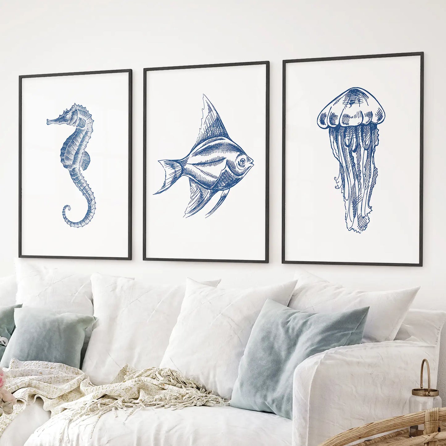 Nautical artwork vertical wall prints. Coastal minimalist contemporary sea life posters. Black frames above the sofa.