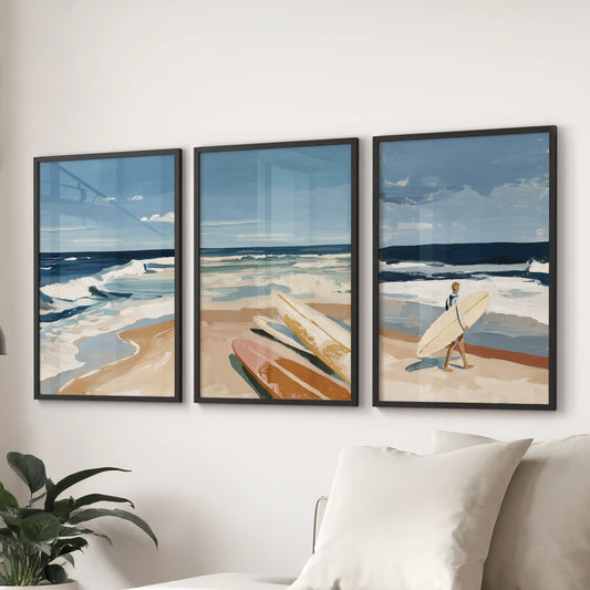 A black-framed set of three coastal seascape prints stretches above the sectional, washing the lounge in soft tide-colored blues.