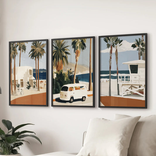 Three retro lifeguard tower prints in black frames create a bright focal wall above the sofa, adding seaside charm to the sitting room.
