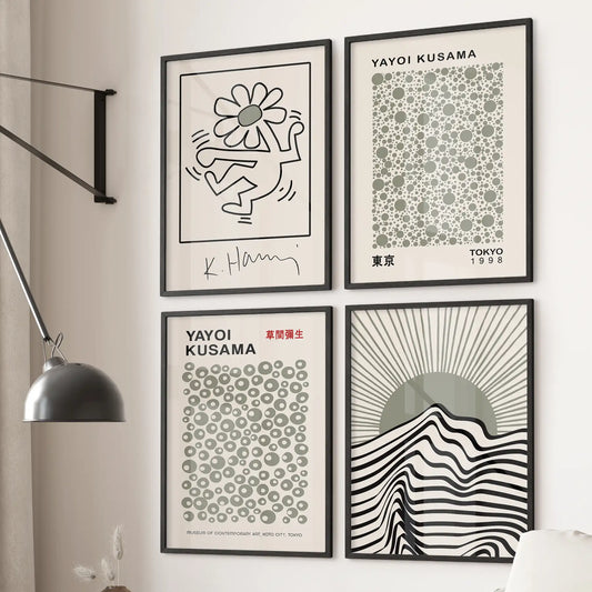 Modern gallery wall with black and grey minimalist art prints, including geometric sunburst and Japanese contemporary designs. Black frames for bedroom.