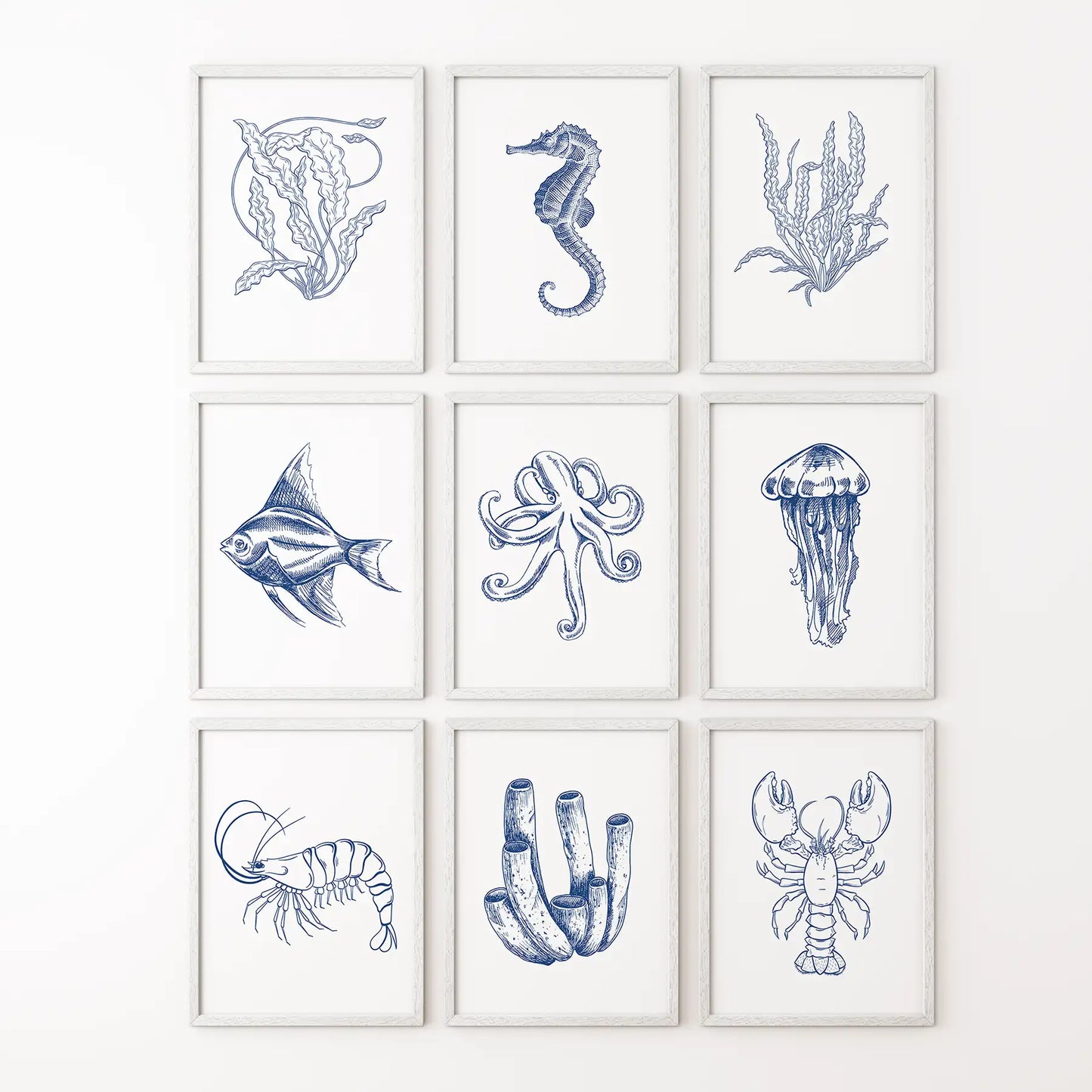 Coastal gallery wall set of 9 nautical art prints in ocean inspired blue tones. White frames for bathroom.