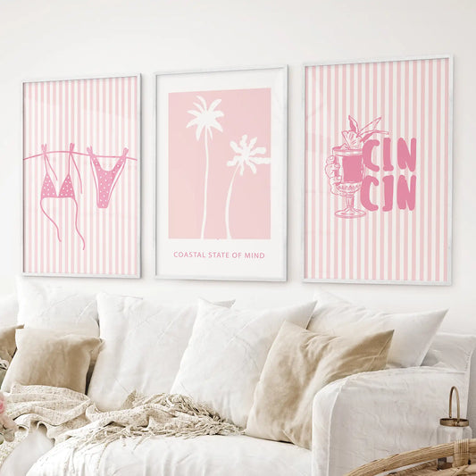 Pink summer wall art set of 3 featuring bikini, palm trees, and tropical drink posters. White frames for living room.