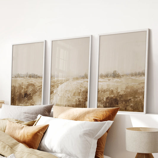 Soft vintage farmhouse landscapes in a three-piece art set with white frames bring quiet texture to the bedroom above the bed.