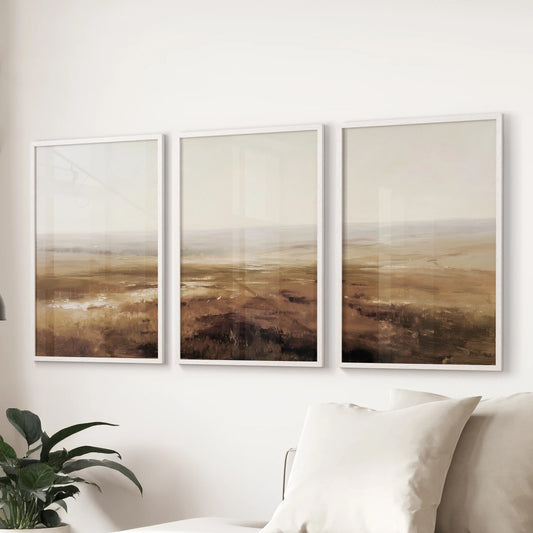 Vintage country scenes, set of three wall art prints in white frames, sit gracefully over a sofa to warm a sitting room with rustic fall mood.