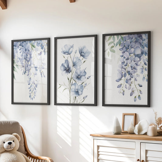 A playful trio of blue watercolor floral prints in black frames brightens the playroom wall above the dresser with airy botanical charm.