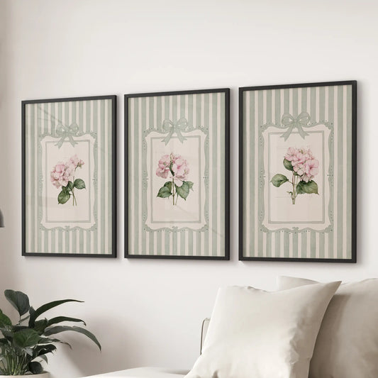 Garden flowers in a three-piece wall art set are black framed above a sofa in the lounge.