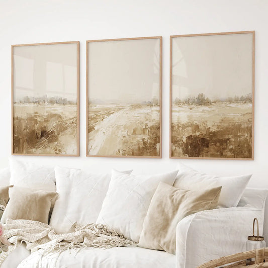 Warm neutral abstract landscape prints. 3 piece watercolor paintings. Thinwood frames over the couch.