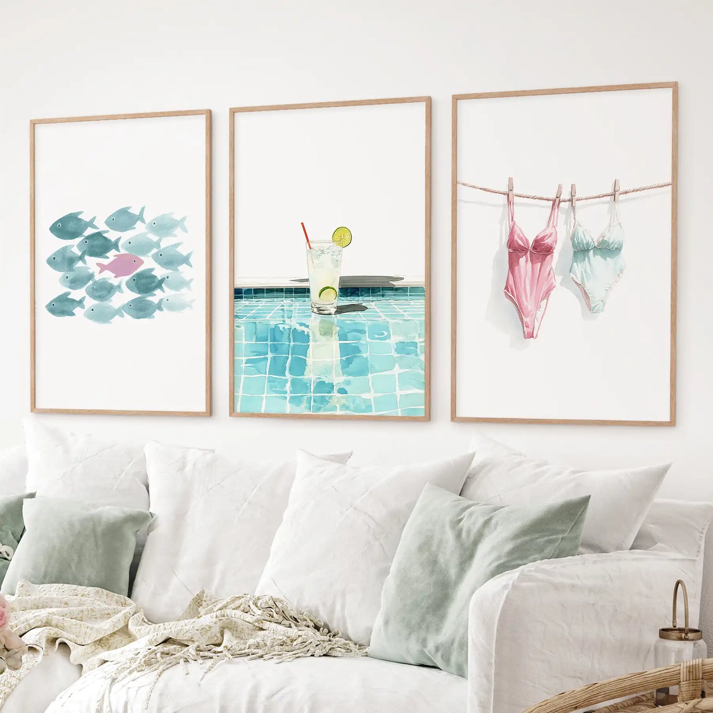 3 piece summer wall art set with watercolor fish, poolside lemonade, and swimsuits. Thinwood frames over the couch.