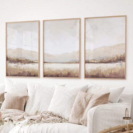 Neutral abstract landscape wall art set of 3 in beige and brown tones. Thinwood frames over the couch.
