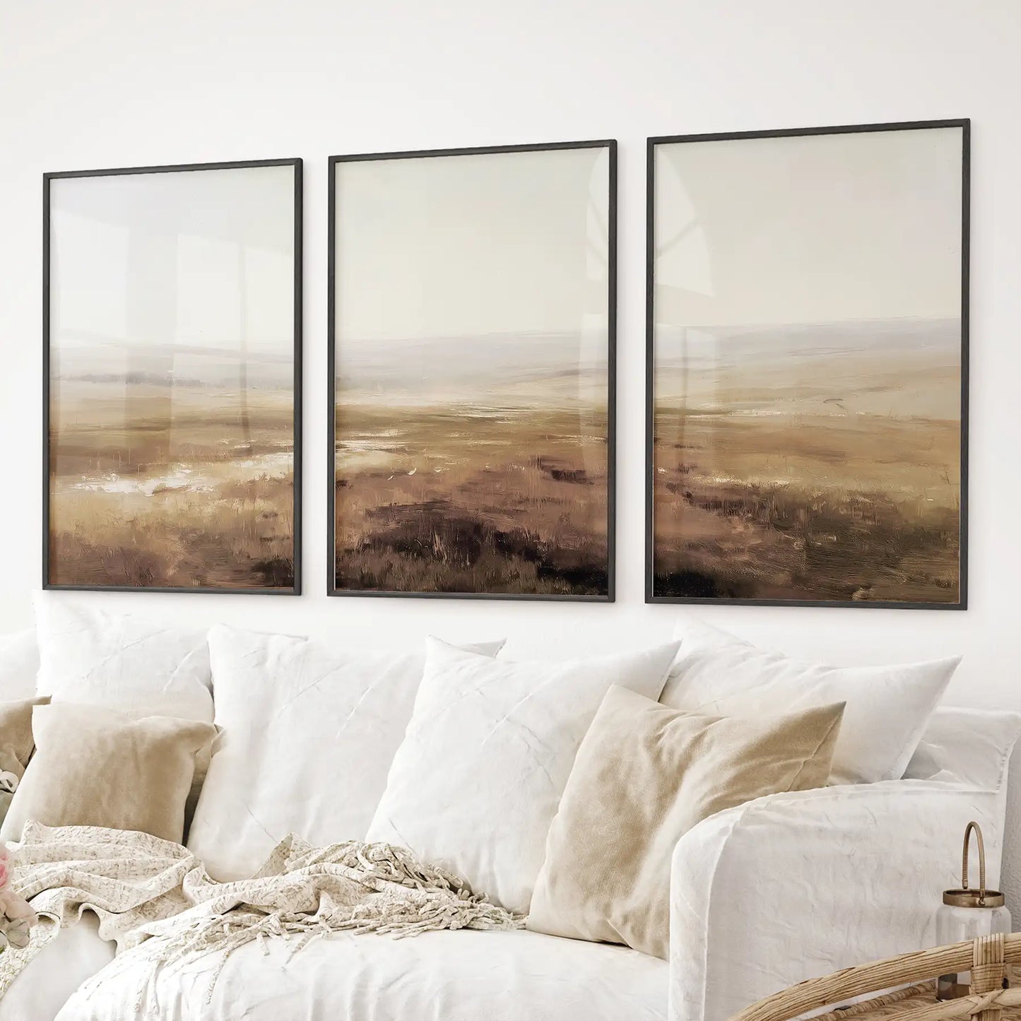 Country painting art print. Abstract landscape wall art featuring soft beige fields and hazy horizons. Black frames above the sofa.