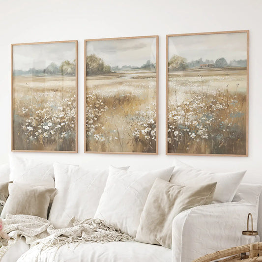 Farmhouse wall art set of 3 with delicate floral meadow landscape in neutral tones. Thinwood frames over the couch.