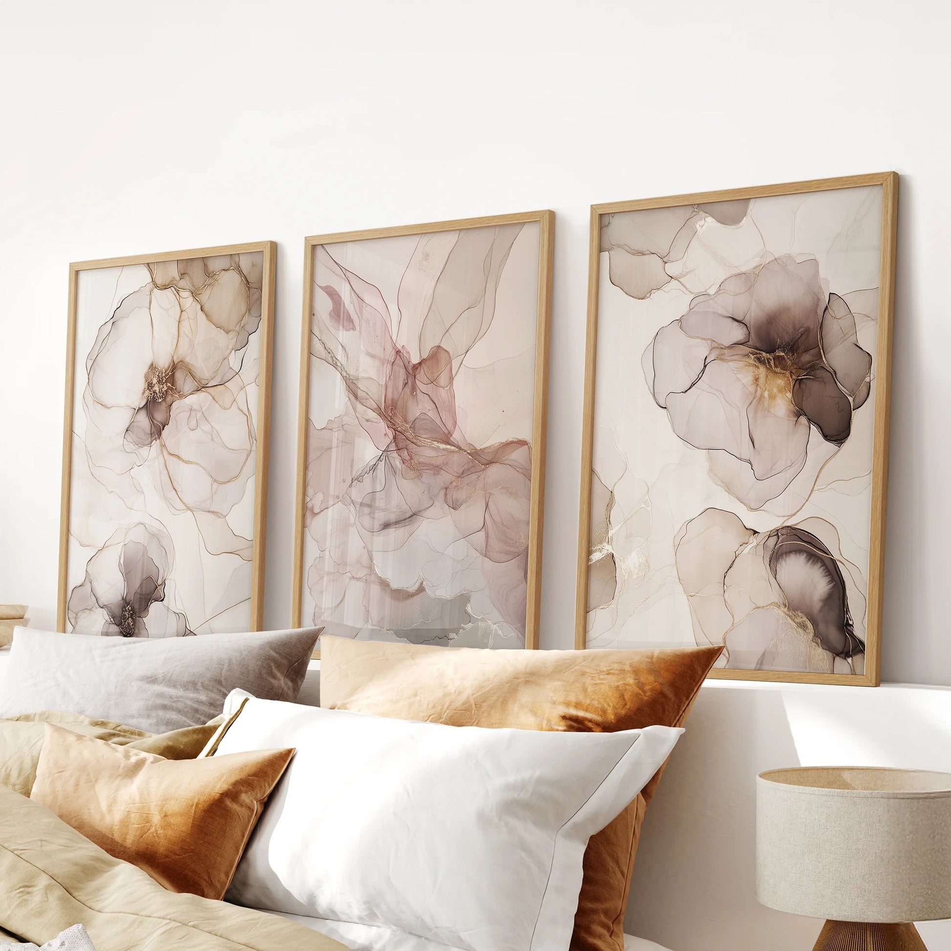 Blush and taupe watercolor wall decor, a 3 piece set in natural wood frames, lends warm elegance to the bedroom above the bed headboard.