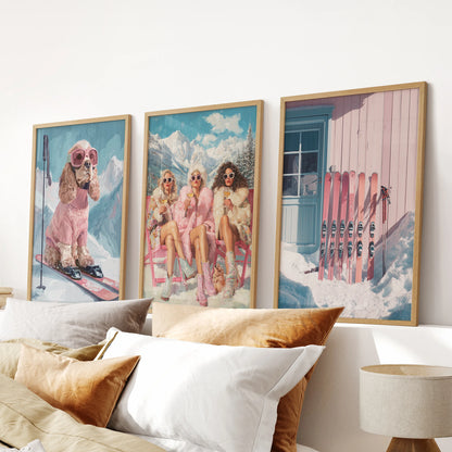 Gallery wall of three alpine ski prints in warm wooden frames fills the bedroom space above the bed's headboard with cozy holiday-lodge allure.