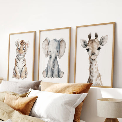 Gender-neutral nursery art trio with watercolor safari portraits. Thinwood frames above the bed.