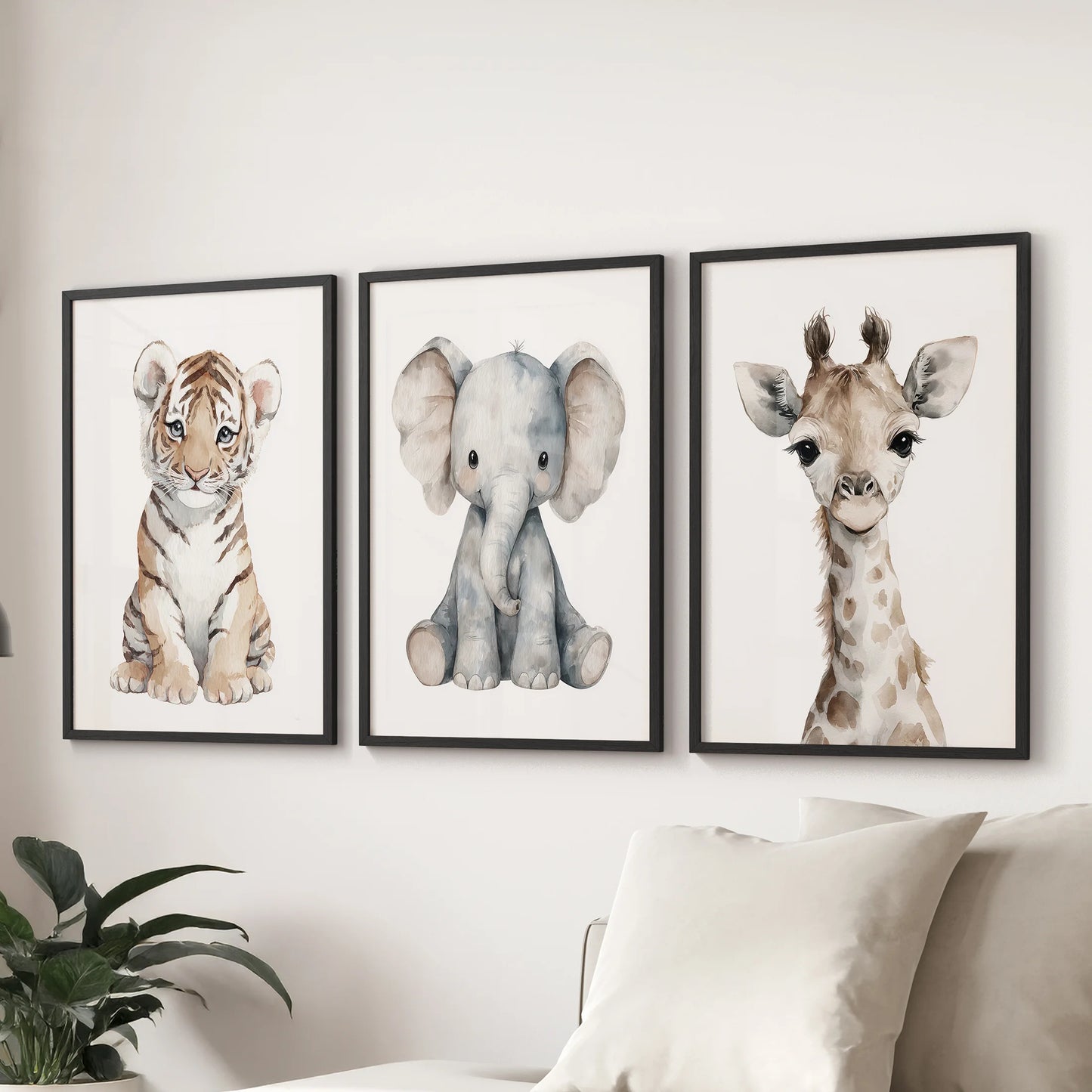 ids room gallery wall featuring baby tiger, elephant, and giraffe illustrations on a soft white wall.
