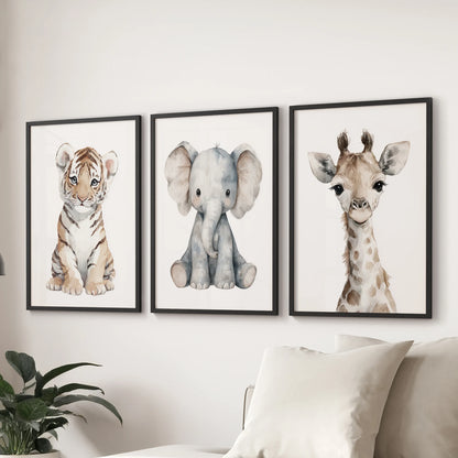 ids room gallery wall featuring baby tiger, elephant, and giraffe illustrations on a soft white wall.