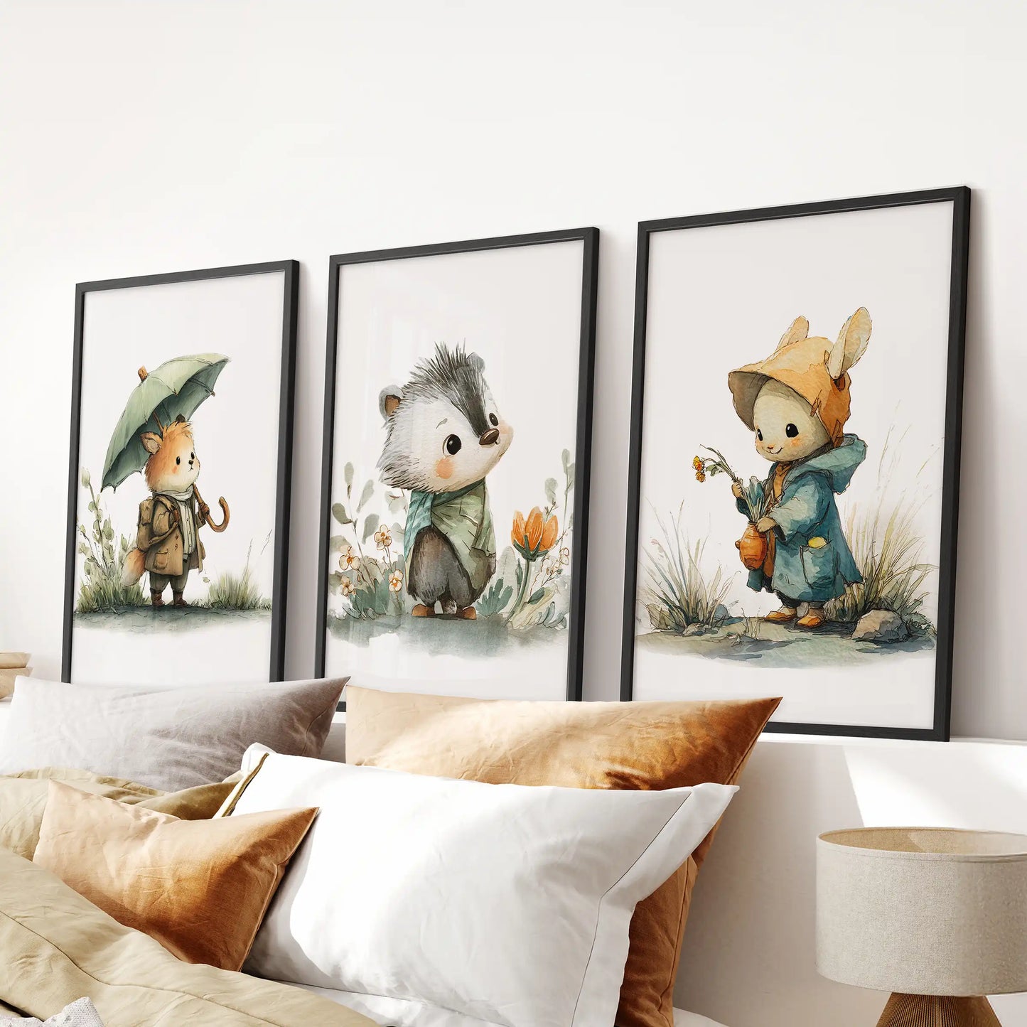 A trio of woodland baby animal prints in black frames brightens the bedroom wall, aligned perfectly over the headboard for a calm, playful touch.