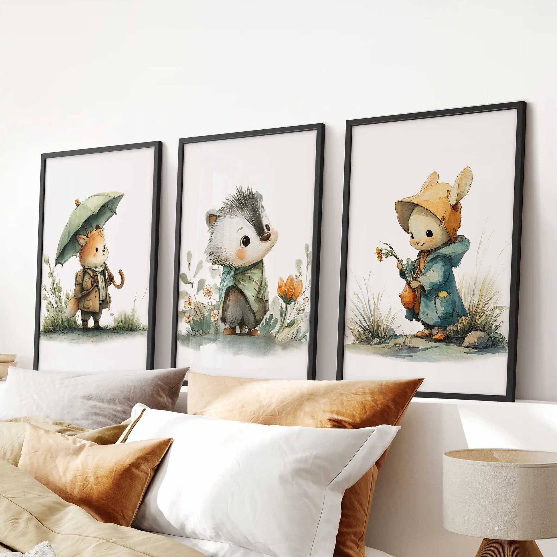 A trio of woodland baby animal prints in black frames brightens the bedroom wall, aligned perfectly over the headboard for a calm, playful touch.