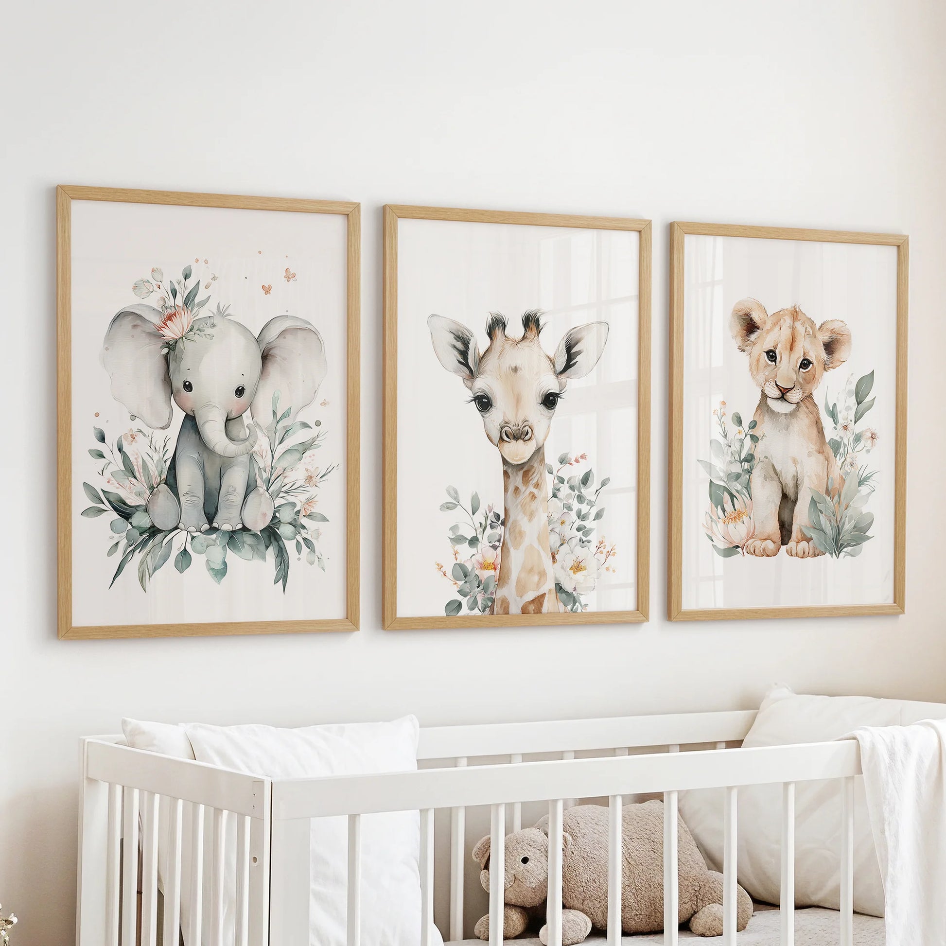 Jungle wildlife 3-print art set, in oak wood frames for the baby nursery, thoughtfully arranged to hang above the crib.
