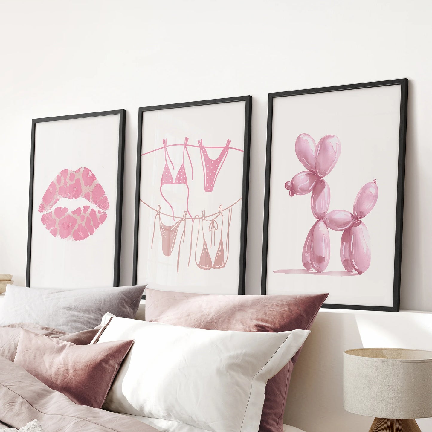 Pink bikini prints, set of 3, create a breezy focal point in the pink bedroom, black frames aligned over the bed headboard for a light, girly gallery.