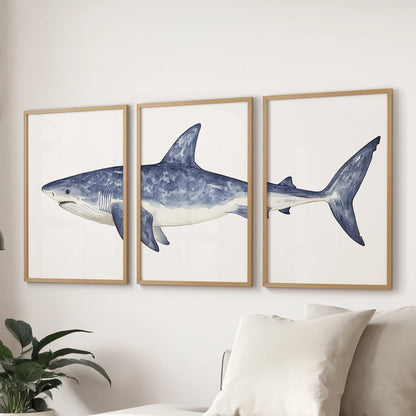 Navy blue coastal sharks, a three-piece wall art set in wood framed prints, complete the living room with a seaside mood, styled above the sectional sofa.